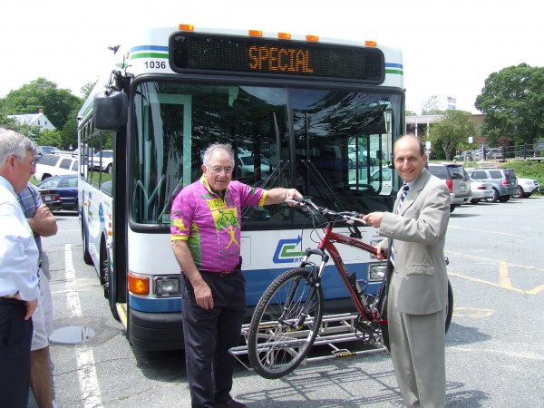 Dr. Ed Gross poses with then-Senator Dan Wolf to highlight bicycle accessibility features of Cape Cod RTA buses.